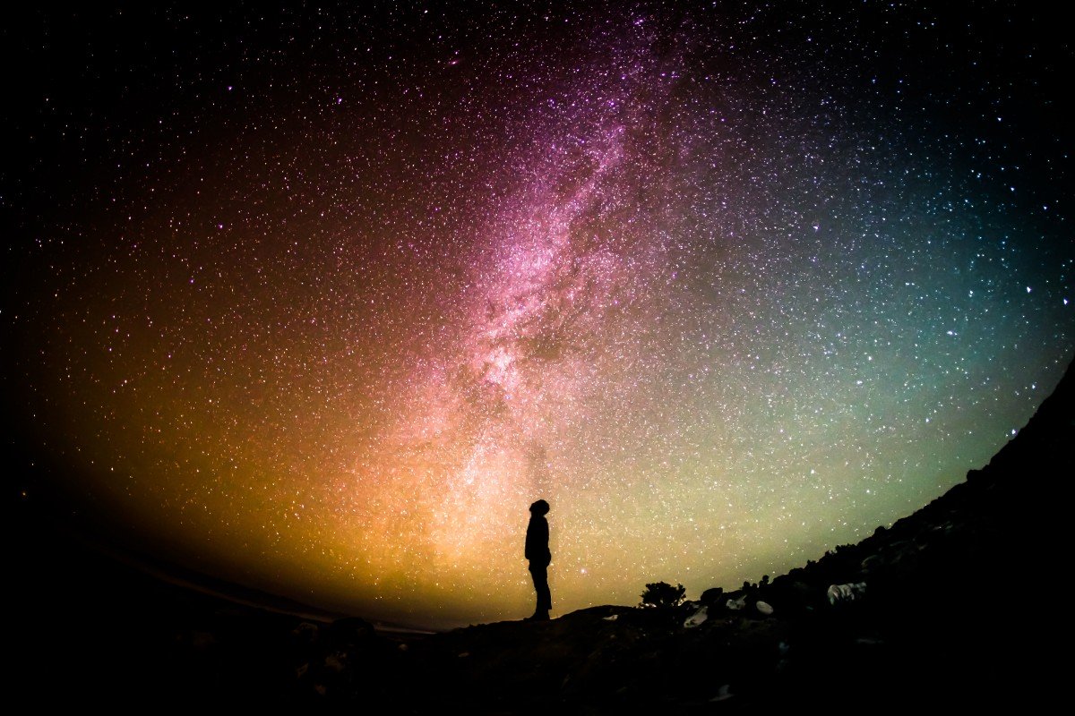 A person standing under the stars